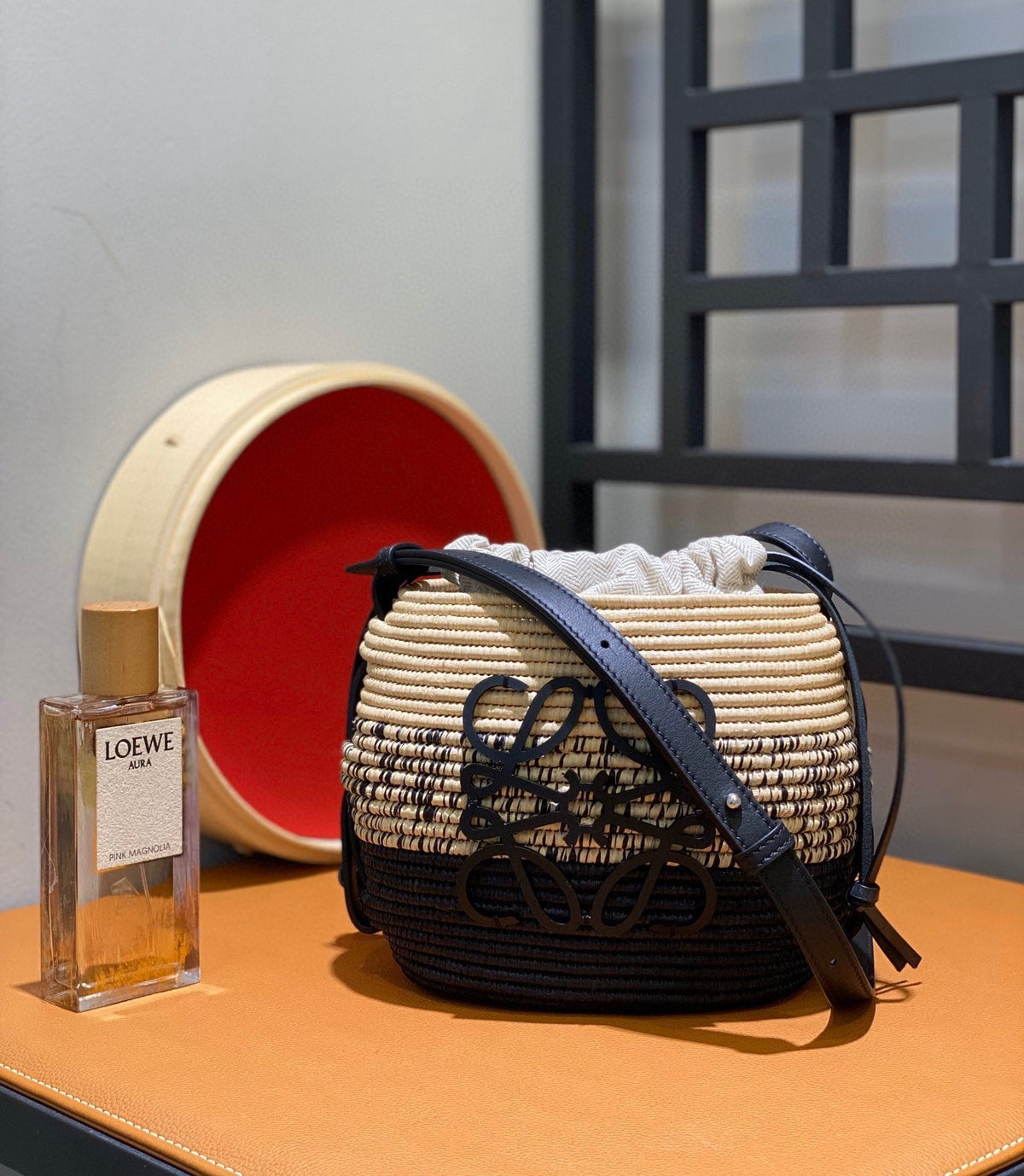 L*E 18 ANAGRAM BASKET BAG IN BLACK AND NATURAL RAFFIA