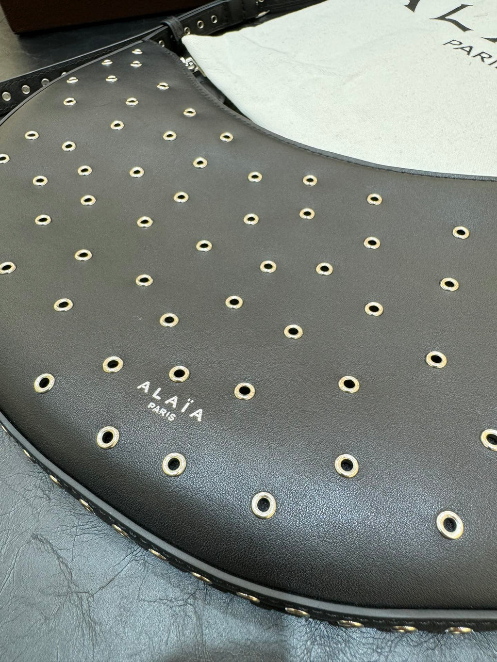 ONE PIECE DEMI LUNE BAG 31 IN BLACK SHEEPSKIN EYELET DETAILING