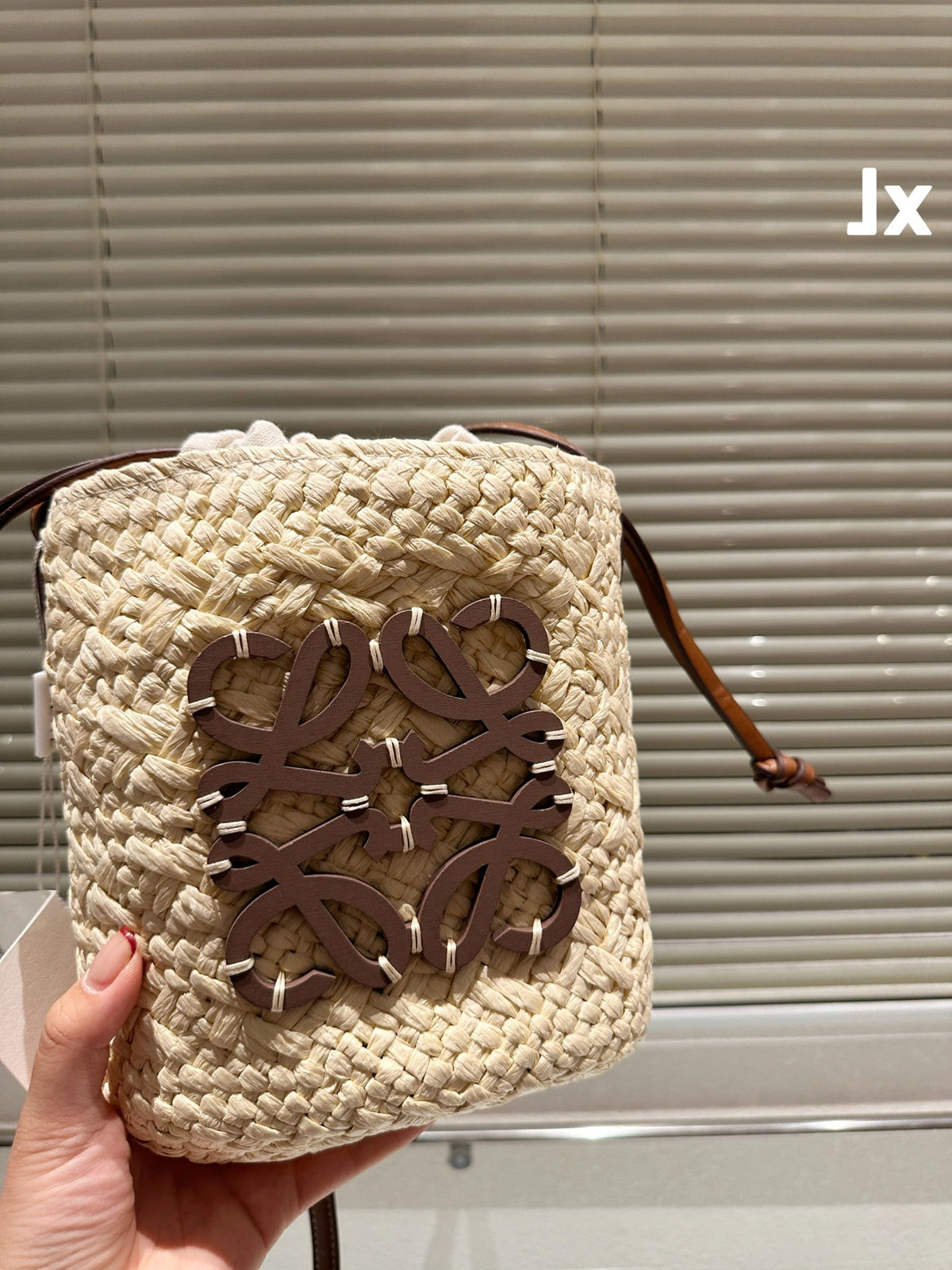 L*E ANAGRAM MINI 18 BUCKET BAG IN NATURAL RAFFIA